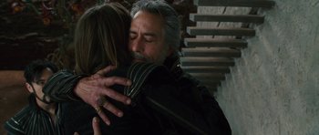 Movie still from “The Tempest” (2010), directed by Julie Taymor – An older man is hugging a younger woman; Close Up shot, Over the shoulder angle