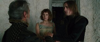 Movie still from “The Tempest” (2010), directed by Julie Taymor – A woman and two men are talking to each other; Medium shot, Over the shoulder angle