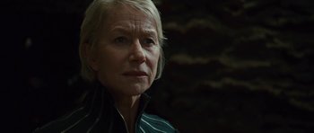 Movie still from “The Tempest” (2010), directed by Julie Taymor – An older woman is looking at the camera; Close Up shot, Low angle