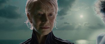 An older woman is looking into the distance