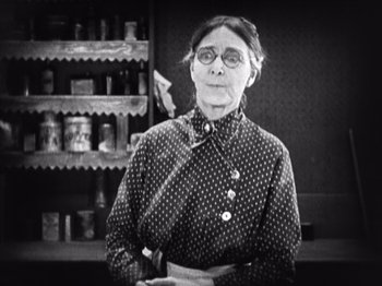 Movie still from “The Ten Commandments” (1923), directed by Cecil B. DeMille – An older woman wearing a polka dot shirt and apron; Medium shot, Low angle