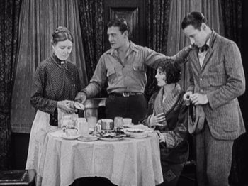 Movie still from “The Ten Commandments” (1923), directed by Cecil B. DeMille – A group of people standing around a table; Medium shot, High angle