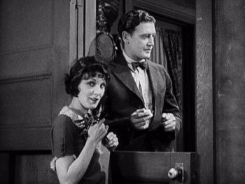 Movie still from “The Ten Commandments” (1923), directed by Cecil B. DeMille – A man and a woman standing next to each other in front of a door; Medium shot, Low angle