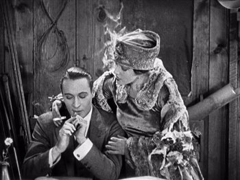 Movie still from “The Ten Commandments” (1923), directed by Cecil B. DeMille – A man and a woman sitting next to each other; Medium shot, Low angle