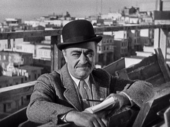 Movie still from “The Ten Commandments” (1923), directed by Cecil B. DeMille – An older man wearing a hat and holding a nintendo wii game controller; Medium shot, Low angle