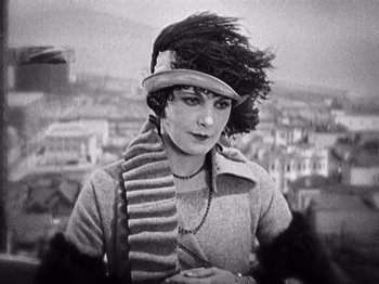 Movie still from “The Ten Commandments” (1923), directed by Cecil B. DeMille – An old photo of a woman in a hat and scarf; Close Up shot, Low angle