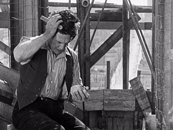 Movie still from “The Ten Commandments” (1923), directed by Cecil B. DeMille – An old photo of a man fixing his hair; Medium shot, High angle