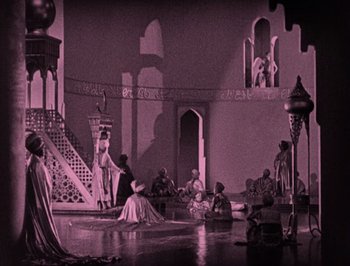 Movie still from “The Thief of Bagdad” (1924), directed by Raoul Walsh – A group of people sitting around in a room; Extreme Wide shot, High angle