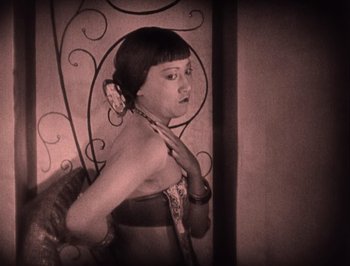 Movie still from “The Thief of Bagdad” (1924), directed by Raoul Walsh – A woman in a black and white photo looking at the camera; Medium shot, High angle