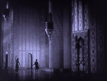 Movie still from “The Thief of Bagdad” (1924), directed by Raoul Walsh – A group of people standing inside of a building; Extreme Wide shot, Low angle