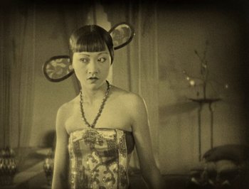 Movie still from “The Thief of Bagdad” (1924), directed by Raoul Walsh – A woman in a dress with a pair of mice on her head; Medium shot, High angle