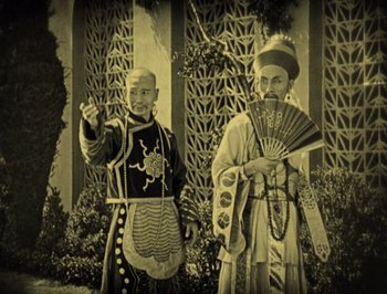 Movie still from “The Thief of Bagdad” (1924), directed by Raoul Walsh – Two men dressed up in ancient chinese clothing; Medium shot, High angle