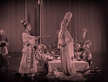 Movie still from “The Thief of Bagdad” (1924), directed by Raoul Walsh – A group of people sitting around a table; Wide shot, High angle