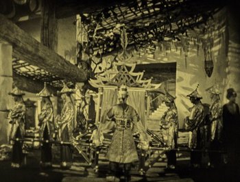 Movie still from “The Thief of Bagdad” (1924), directed by Raoul Walsh – A group of men standing in front of a building; Wide shot, High angle