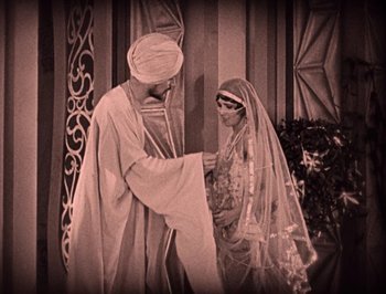 Movie still from “The Thief of Bagdad” (1924), directed by Raoul Walsh – A man and a woman dressed in medieval garb; Medium shot, High angle
