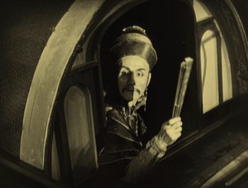 Movie still from “The Thief of Bagdad” (1924), directed by Raoul Walsh – An old photo of a man holding a baseball bat; Medium shot, Low angle