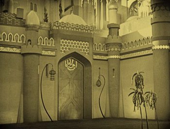 Movie still from “The Thief of Bagdad” (1924), directed by Raoul Walsh – An old photo of a castle with a palm tree in front of it; Extreme Wide shot, Low angle