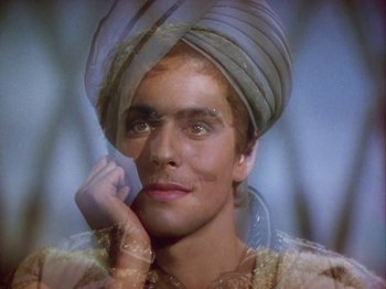 Movie still from “The Thief of Bagdad” (1940), directed by Alexander Korda – A man wearing a turban and a white shirt; Close Up shot, Low angle