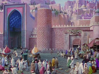 Movie still from “The Thief of Bagdad” (1940), directed by Alexander Korda – A painting of people gathered in front of a large building; Extreme Wide shot, High angle