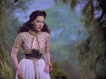 Movie still from “The Thief of Bagdad” (1940), directed by Alexander Korda – A woman wearing a dress and a necklace; Medium shot, Low angle