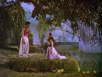 Movie still from “The Thief of Bagdad” (1940), directed by Alexander Korda – Two women are standing near a body of water; Extreme Wide shot, High angle