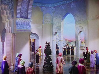 Movie still from “The Thief of Bagdad” (1940), directed by Alexander Korda – A group of people standing in a room with arches; Extreme Wide shot, High angle