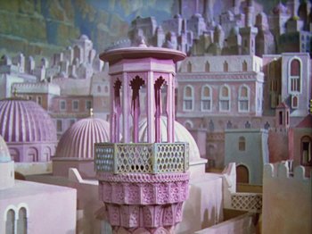Movie still from “The Thief of Bagdad” (1940), directed by Alexander Korda – A painting of an old city with a pink tower; Extreme Wide shot, High angle