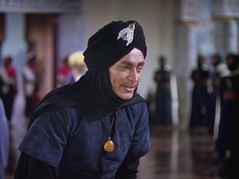 Movie still from “The Thief of Bagdad” (1940), directed by Alexander Korda – A man wearing a turban and smiling for the camera; Medium shot, High angle