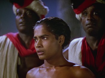 Movie still from “The Thief of Bagdad” (1940), directed by Alexander Korda – A man standing in front of two other men; Close Up shot, High angle