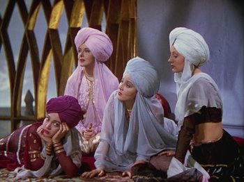 Movie still from “The Thief of Bagdad” (1940), directed by Alexander Korda – A group of women sitting next to each other wearing turbans; Medium shot, High angle