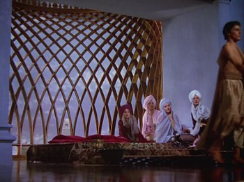 Movie still from “The Thief of Bagdad” (1940), directed by Alexander Korda – A group of people sitting on top of a wooden structure; Wide shot, Low angle