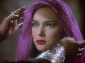 Movie still from “The Thief of Bagdad” (1940), directed by Alexander Korda – A person wearing a purple headscarf; Close Up shot, Over the shoulder angle