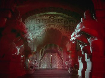 Movie still from “The Thief of Bagdad” (1940), directed by Alexander Korda – A hallway with a lot of statues on the walls; Extreme Wide shot, High angle