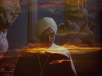 Movie still from “The Thief of Bagdad” (1940), directed by Alexander Korda – A woman with a turban is standing in front of a sunset; Medium shot, Low angle