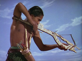 Movie still from “The Thief of Bagdad” (1940), directed by Alexander Korda – A young man is holding a bow and arrow; Medium shot, High angle