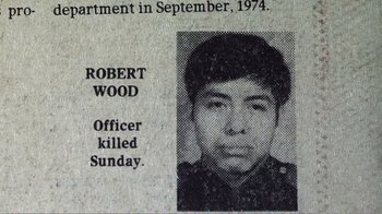 Movie still from “The Thin Blue Line” (1988), directed by Errol Morris – A newspaper clipping of a police officer who was killed on sunday; Close Up shot, Overhead angle