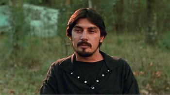 Movie still from “The Thin Blue Line” (1988), directed by Errol Morris – A person wearing a black shirt; Close Up shot, Low angle