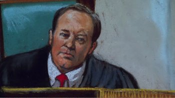 Movie still from “The Thin Blue Line” (1988), directed by Errol Morris – A man in a court room wearing a suit and red tie; Close Up shot, Low angle