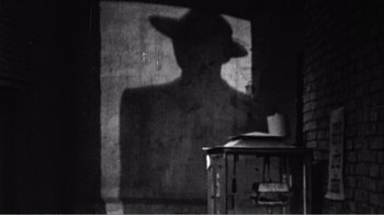 Movie still from “The Thin Blue Line” (1988), directed by Errol Morris – The shadow of a person wearing a cowboy hat; Close Up shot, Low angle