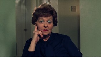 Movie still from “The Thin Blue Line” (1988), directed by Errol Morris – An older woman is sitting in front of a mirror; Close Up shot, High angle