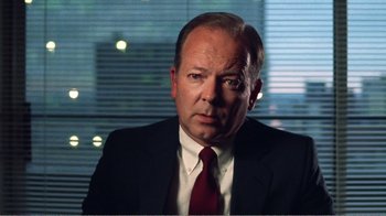 Movie still from “The Thin Blue Line” (1988), directed by Errol Morris – A man in a suit and red neck tie; Close Up shot, Low angle