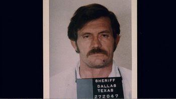 Movie still from “The Thin Blue Line” (1988), directed by Errol Morris – A mugshot of a man in a white shirt and tie; Close Up shot, High angle