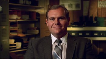 Movie still from “The Thin Blue Line” (1988), directed by Errol Morris – A person wearing a suit and tie; Close Up shot, Low angle