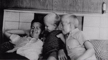 Movie still from “The Thin Blue Line” (1988), directed by Errol Morris – An old photo of a man and two young boys; Medium shot, High angle