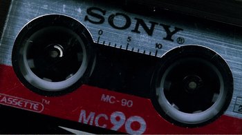 Movie still from “The Thin Blue Line” (1988), directed by Errol Morris – View of a cassette tape; Extreme Close Up shot, Overhead angle