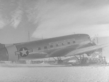 Movie still from “The Thing from Another World” (1951), directed by Howard Hawks – An air force plane with a star on the side of it; Wide shot, Low angle