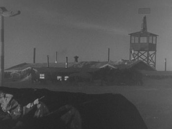 Movie still from “The Thing from Another World” (1951), directed by Howard Hawks – A black - and - white photo of a military base; Extreme Wide shot, High angle