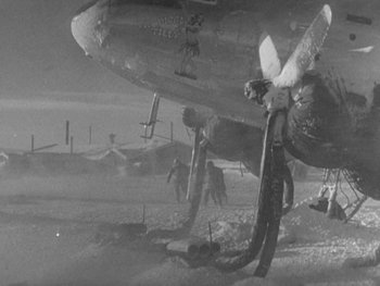 Movie still from “The Thing from Another World” (1951), directed by Howard Hawks – An airplane is parked on the ground in the snow; Wide shot, High angle