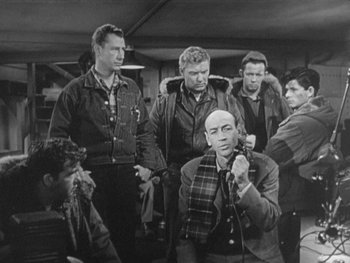 Movie still from “The Thing from Another World” (1951), directed by Howard Hawks – A black and white photo of a group of people; Medium shot, High angle