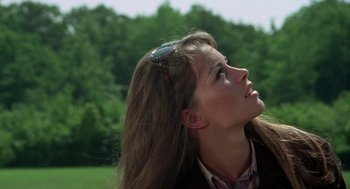 Movie still from “The Thomas Crown Affair” (1968), directed by Norman Jewison – A woman with long brown hair wearing a headband; Close Up shot, Low angle